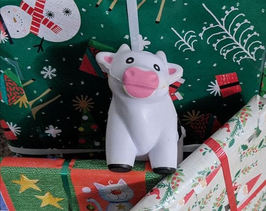 Mad Cow's squeezable mascot Patty sits among a pile of wrapped Christmas presents
