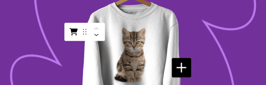 A white sweatshirt with a tabby kitten on the front hangs from a hanger in front of a purple background.