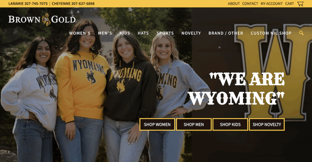 Homepage hero image for the Brown and Gold website, featuring four smiling college students donning University of Wyoming sweatshirts.